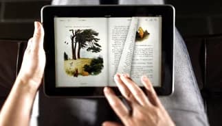 Hands holding a tablet displaying an ebook