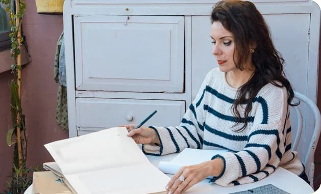 Editor reviewing a manuscript at a desk